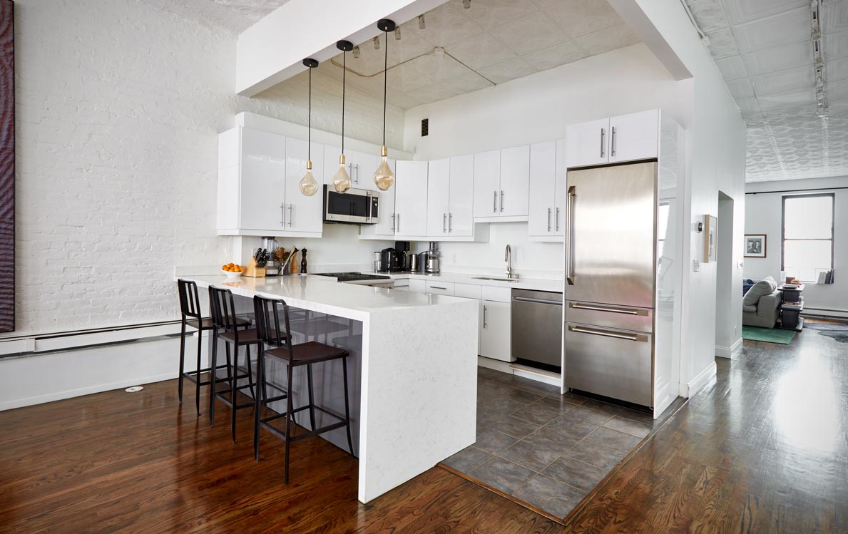 cocoon boto First floor kitchen with hanging lights white cabinetry and black counter stools cocoon boto First floor kitchen with hanging lights white cabinetry and black counter stools