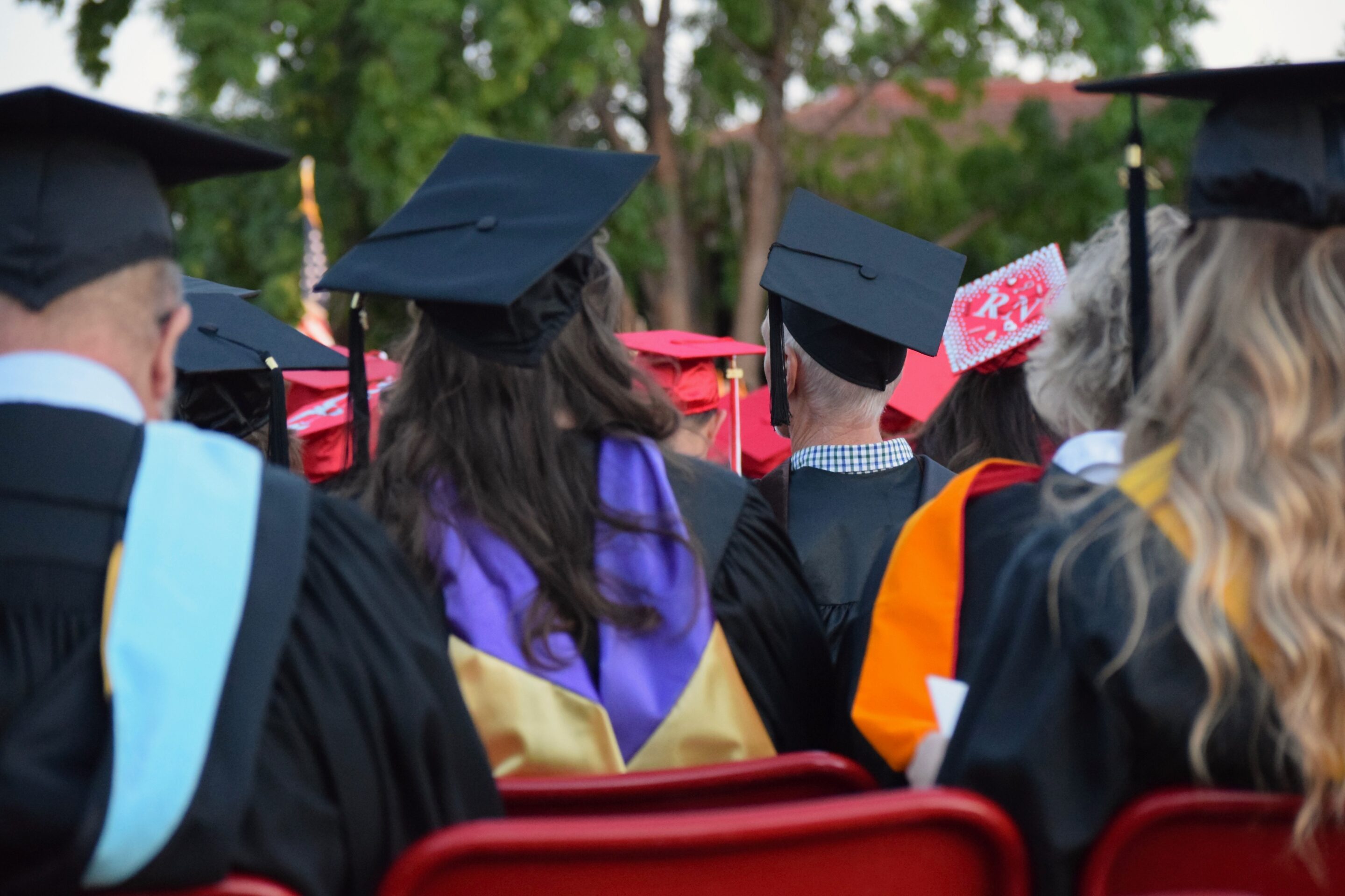 jane carmona 8GVsvPuiLUA unsplash students seated at outdoor graduation venue