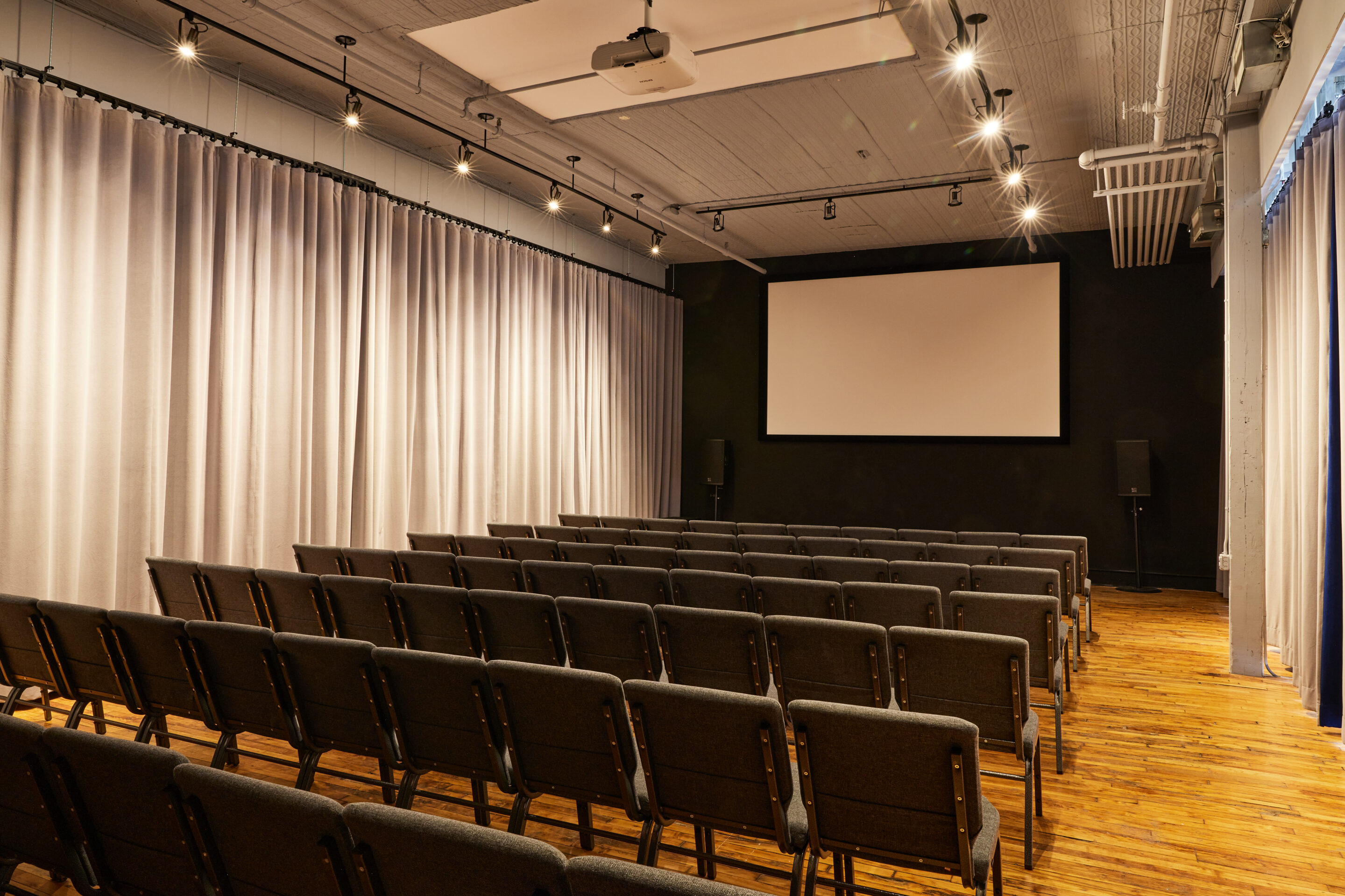 Casa Kino event space with chairs and projector screen Casa Kino event space with chairs and projector screen