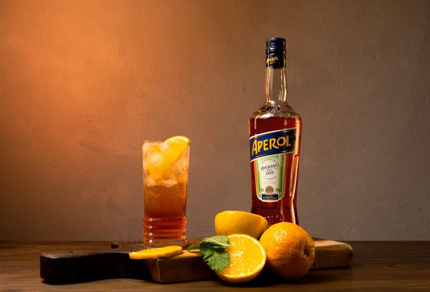 bottle of aperol and full glass with oranges for rooftop baby shower nyc