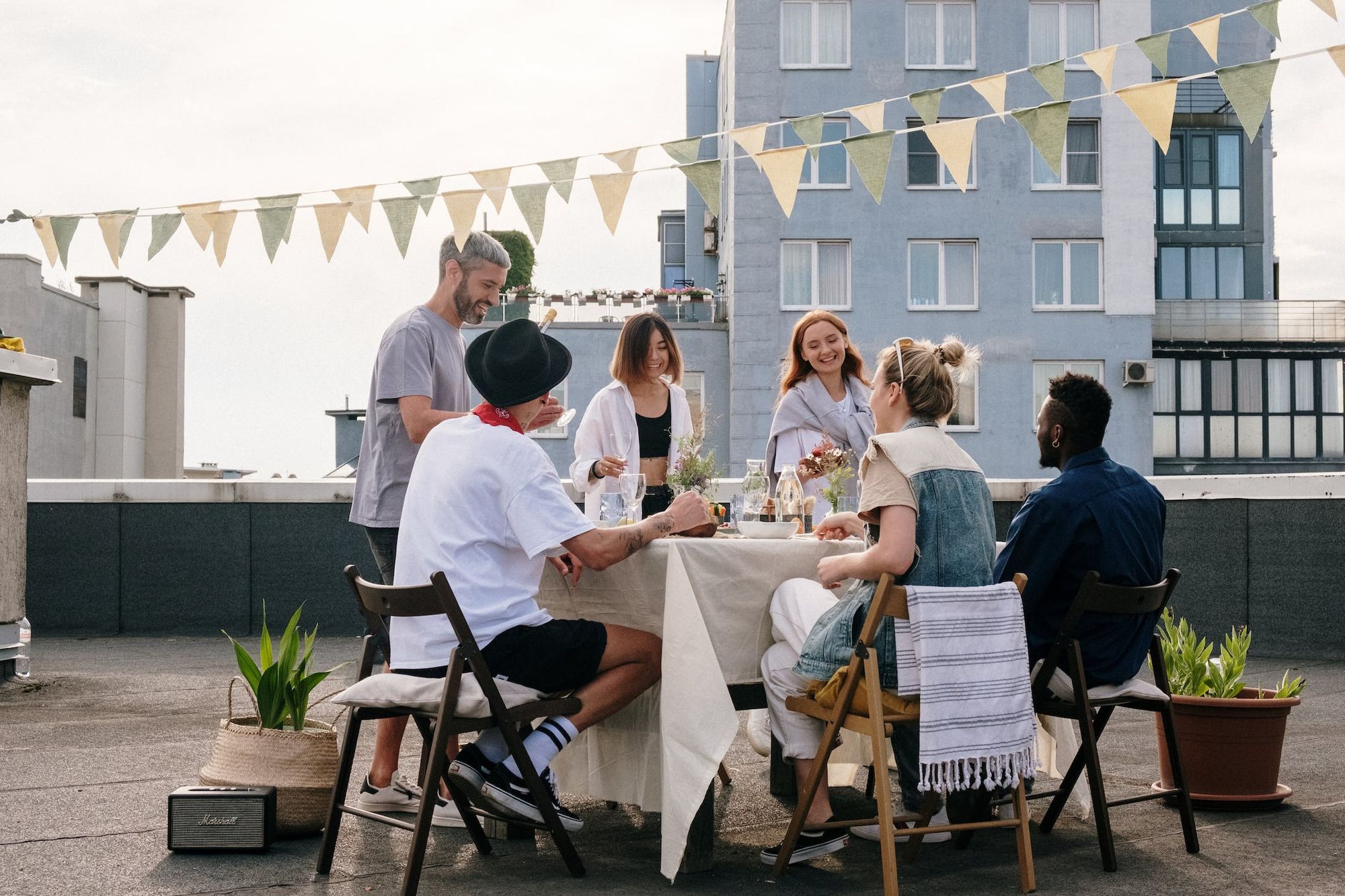 guests sitting around table eating at rooftop baby shower
