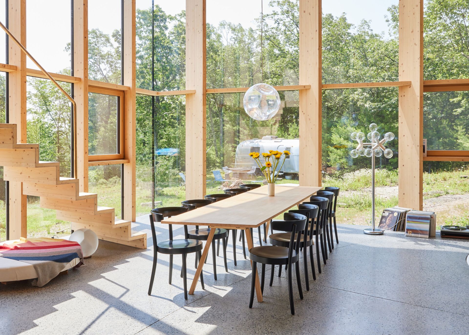 4 Casa Cometa Space Rental Interior Dining Room facing south with glass pendant and oakwood dining table and black dining chairs and staircase and floor to ceiling windows 4 Casa Cometa Space Rental Interior Dining Room facing south with glass pendant and oakwood dining table and black dining chairs and staircase and floor to ceiling windows