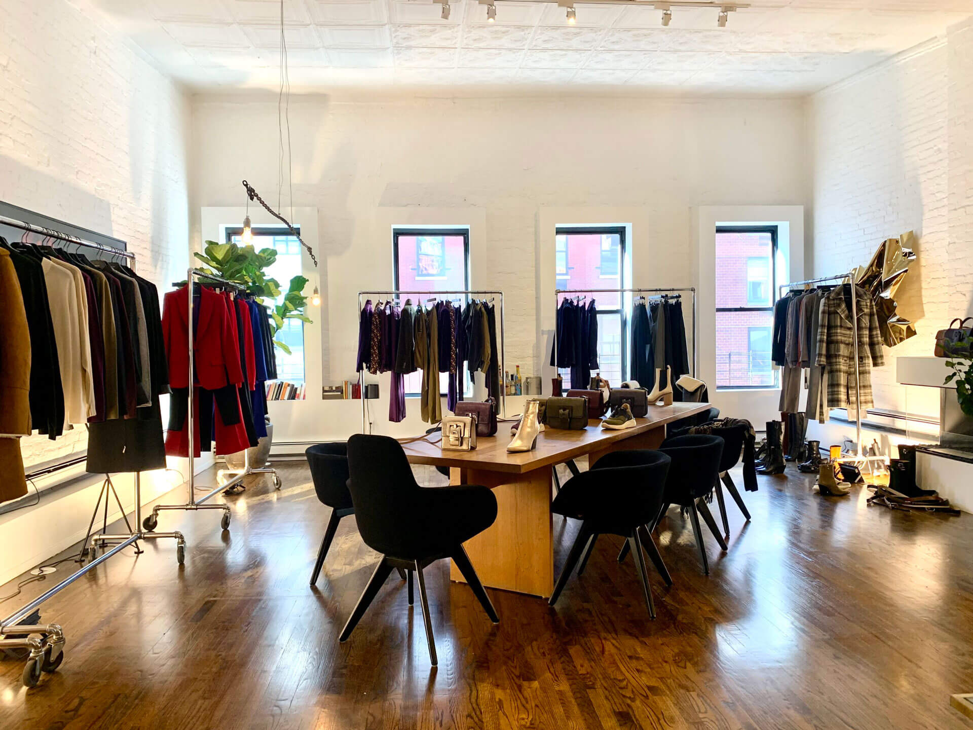casa boto fashion showroom space rental_tribeca loft with high ceilings wooden floors clothing rack displays dining table accessories display and black tom dixon dining chairs casa boto fashion showroom space rental_tribeca loft with high ceilings wooden floors clothing rack displays dining table accessories display and black tom dixon dining chairs